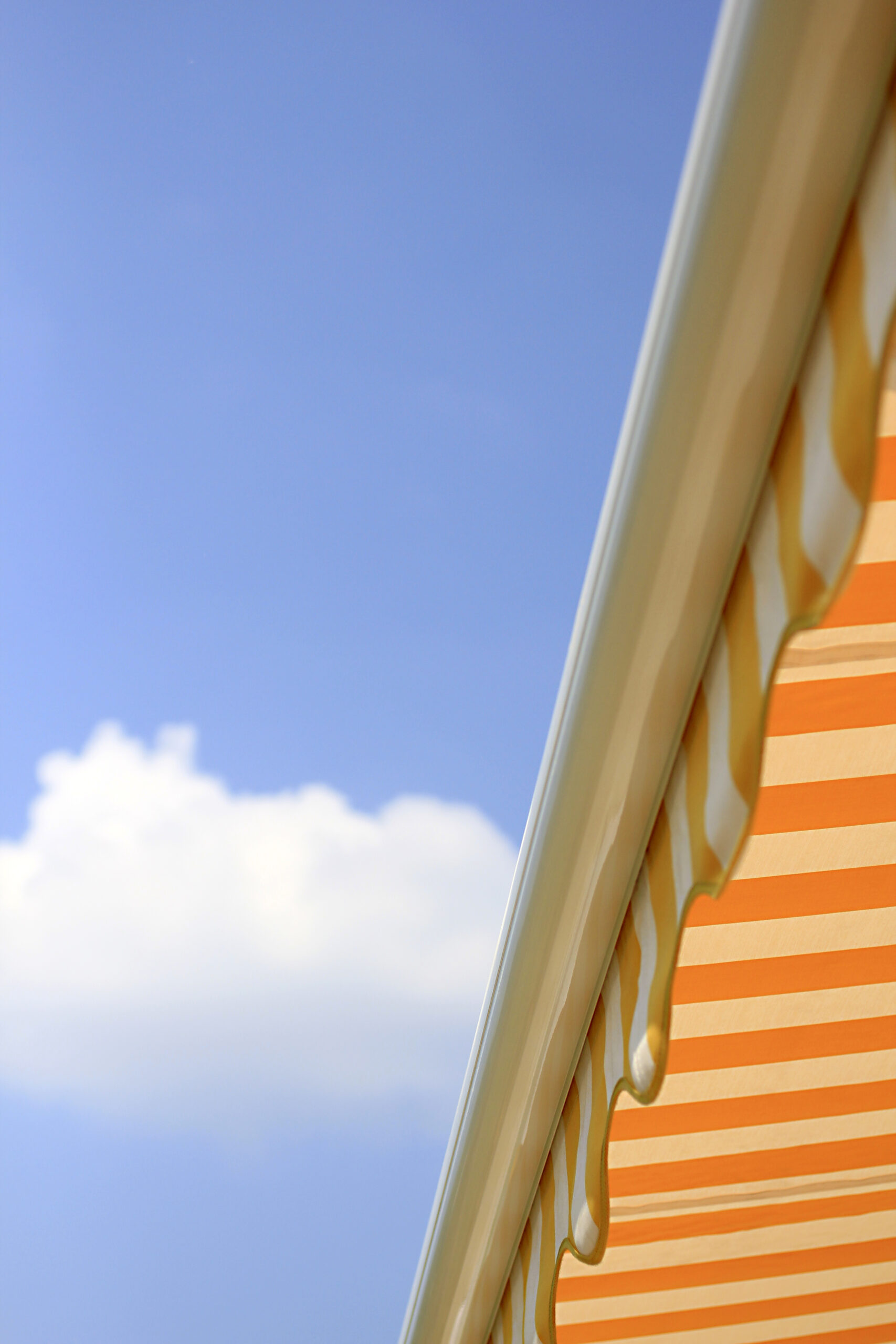 yellow sun awning against blue sky